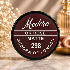 Medora 298 matte lip color compact, round black case with burgundy label