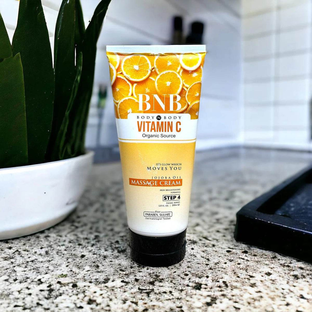 BNB Vitamin C Massage Cream tube, white and gold with orange citrus design