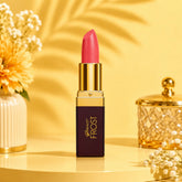 Pink lipstick in gold tube with capped bullet, Frost label on dark rectangular base