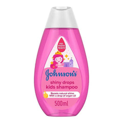 Pink kids shampoo bottle with white cap; Johnsons Shiny Drops label.