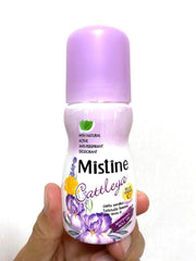 Hand holding Mistine Cattleya roll-on deodorant bottle with purple cap