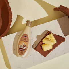 Shea butter body lotion bottle beside shea butter and cream textures