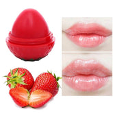 Strawberry-shaped red lip balm; balm sheen on lips