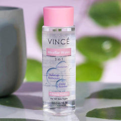 VINCÉ micellar water bottle with pink cap, upright on tabletop.