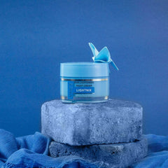 Vince skin lightening night cream jar on gray stone pedestal with blue lid