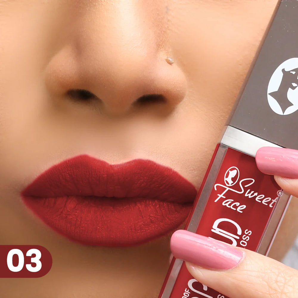 Lip gloss tube and wand applying deep red lip color, shade 03