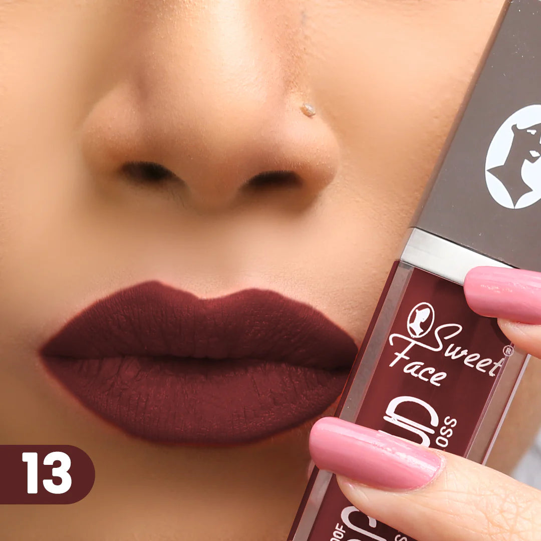 Lip gloss on lips with rose-pink applicator, dark maroon berry finish
