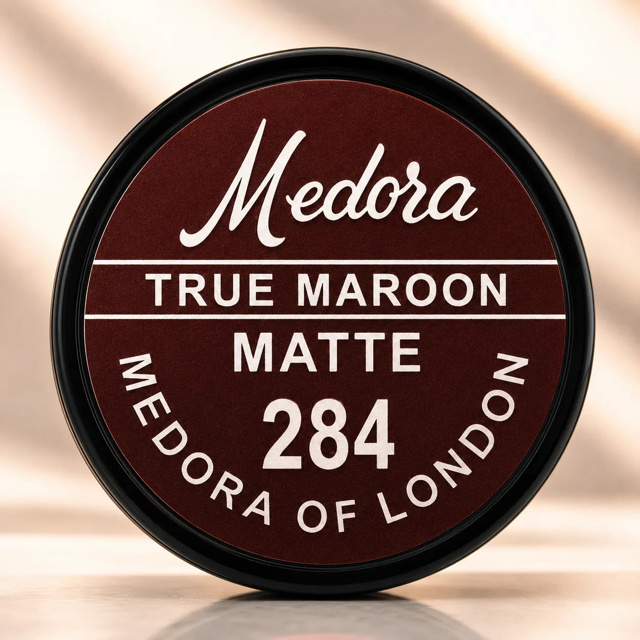 Matte lipstick cap labeled True Maroon 284