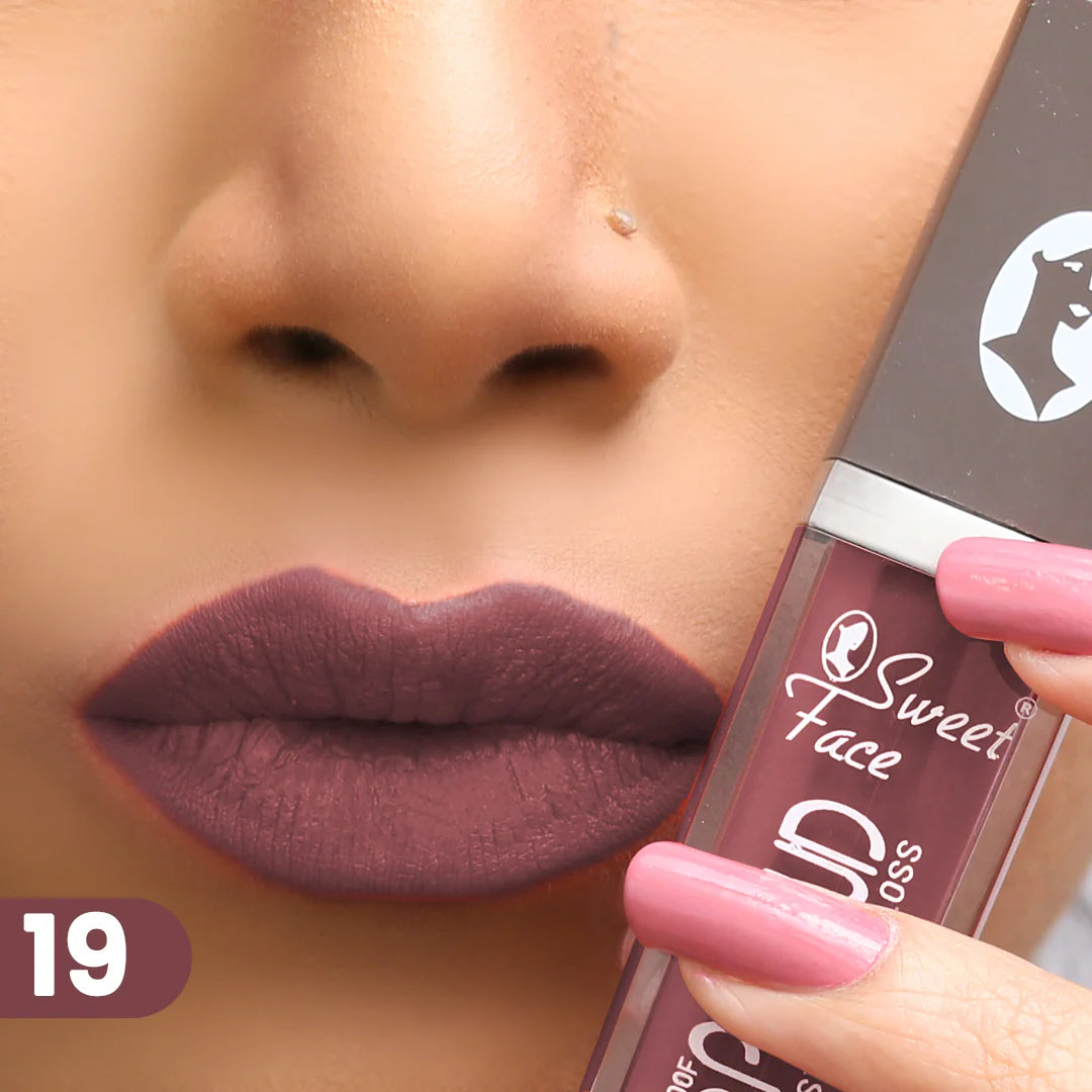 Lip gloss on lips with rose-pink applicator, muted plum rosy finish
