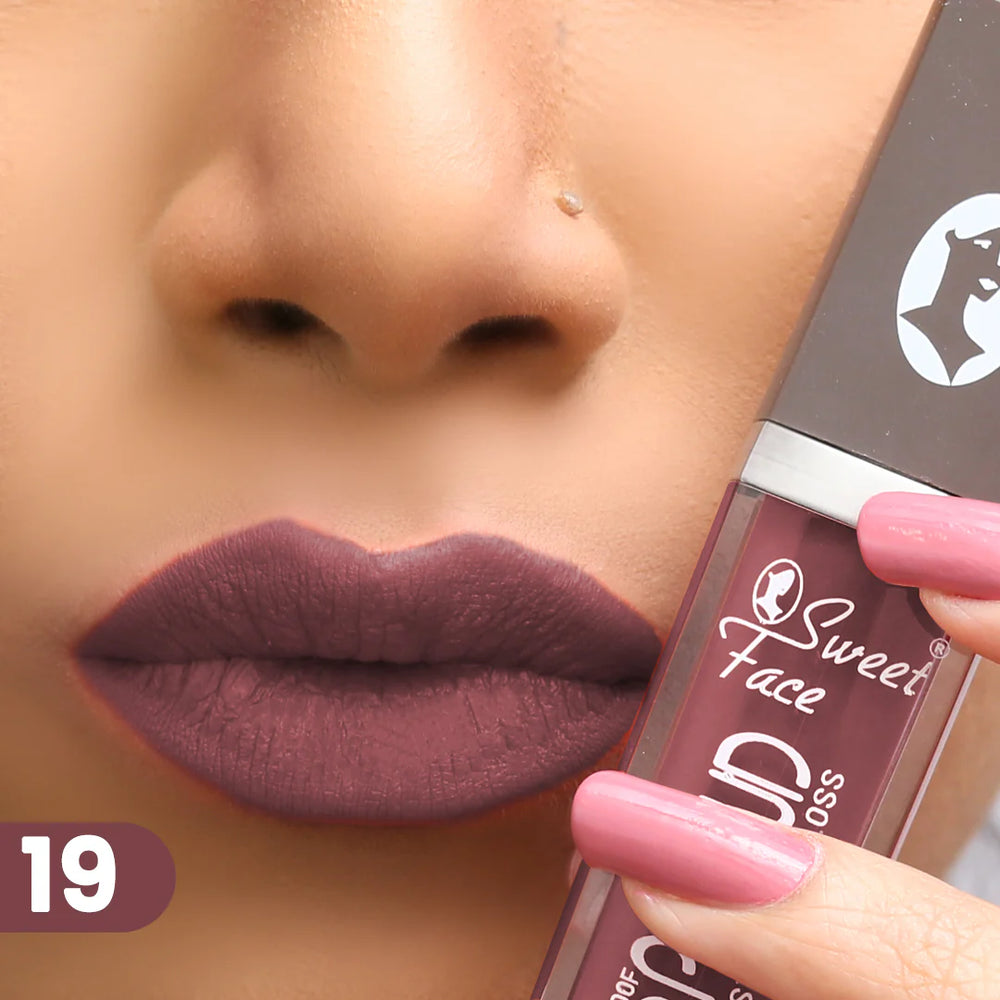 Lip gloss on lips with rose-pink applicator, muted plum rosy finish