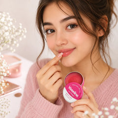 Rosy lips lip balm tin with pink balm; woman applies balm near lips