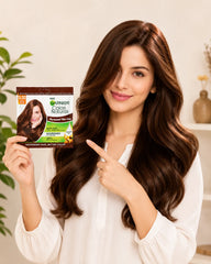 Hair color sachet box held in hand, 5.32 dark caramel brown, Garnier Color Naturals