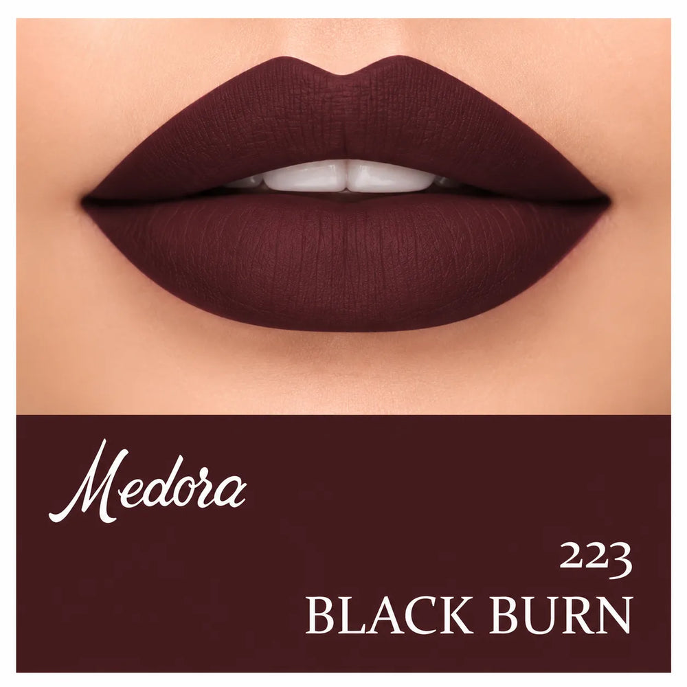 Close-up of dark berry lips with lipstick swatch