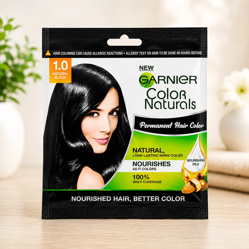 Hair color sachet for 1.0 natural black, shown on table with branded front and hair portrait.
