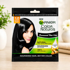 Hair color sachet for 1.0 natural black, shown on table with branded front and hair portrait.