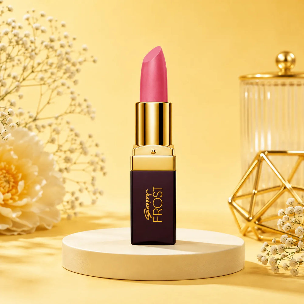 Pink lipstick in gold bullet tube on white pedestal, Frost label visible on dark case