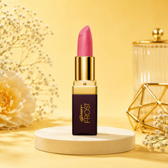 Pink lipstick in gold bullet tube on white pedestal, Frost label visible on dark case