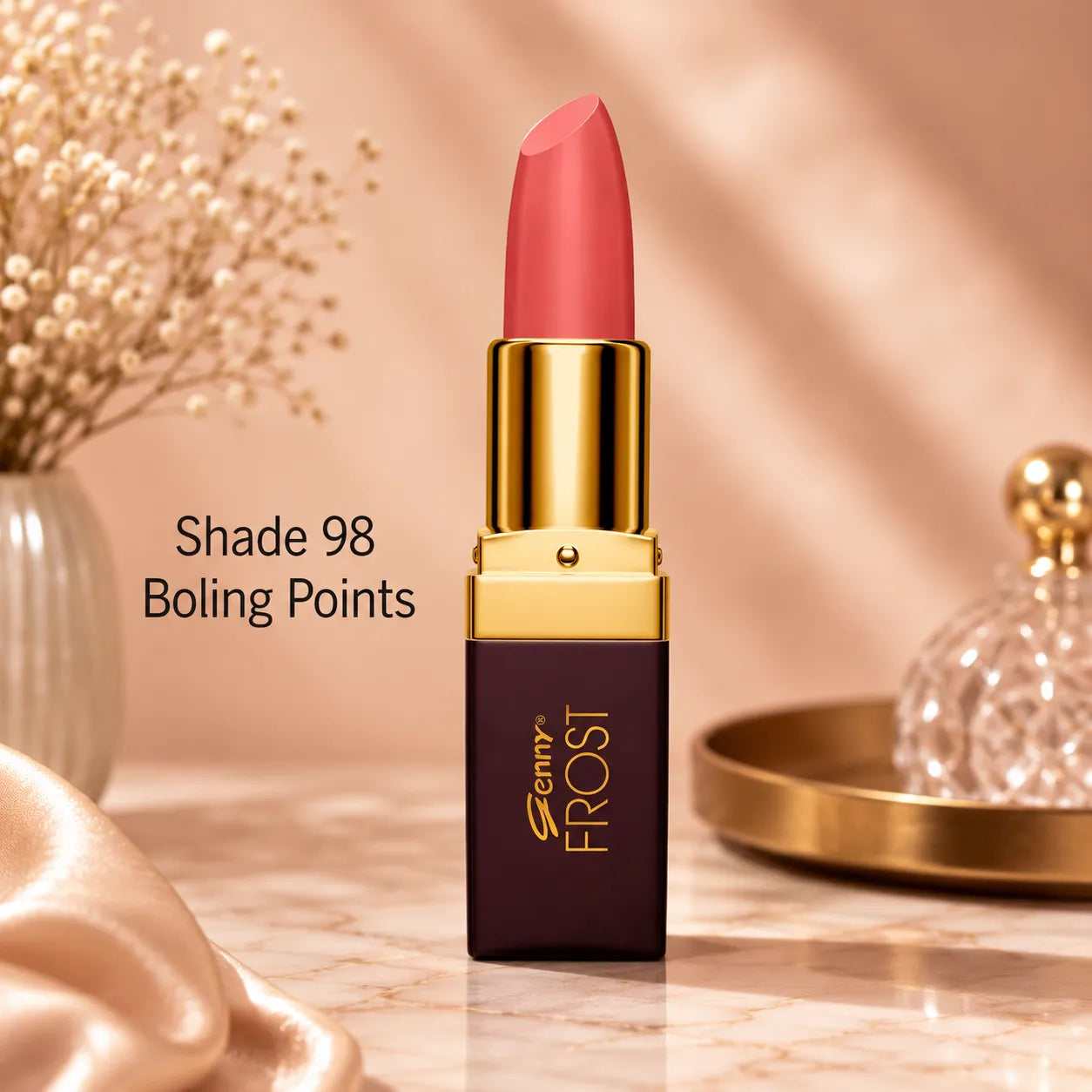 Coral red lipstick with gold bullet cap and dark maroon tube, upright view
