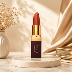 Genny Frost lipstick with reddish-brown bullet, gold cap, and maroon tube