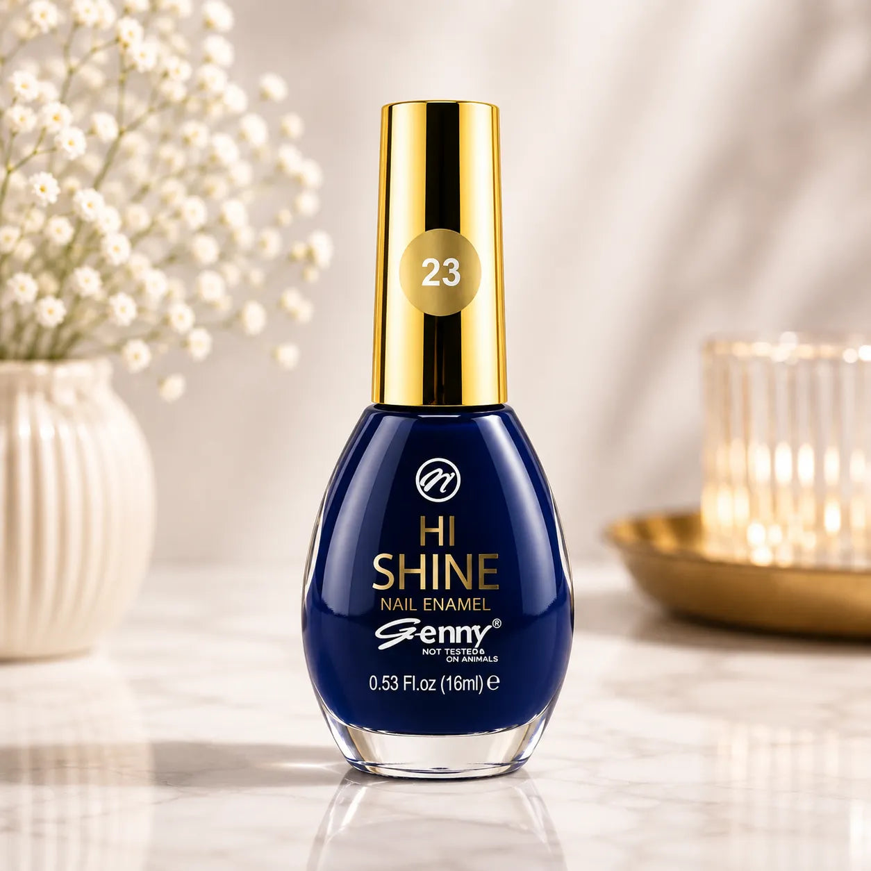Blue nail enamel bottle, gold cap with 23 label and glossy rounded glass.