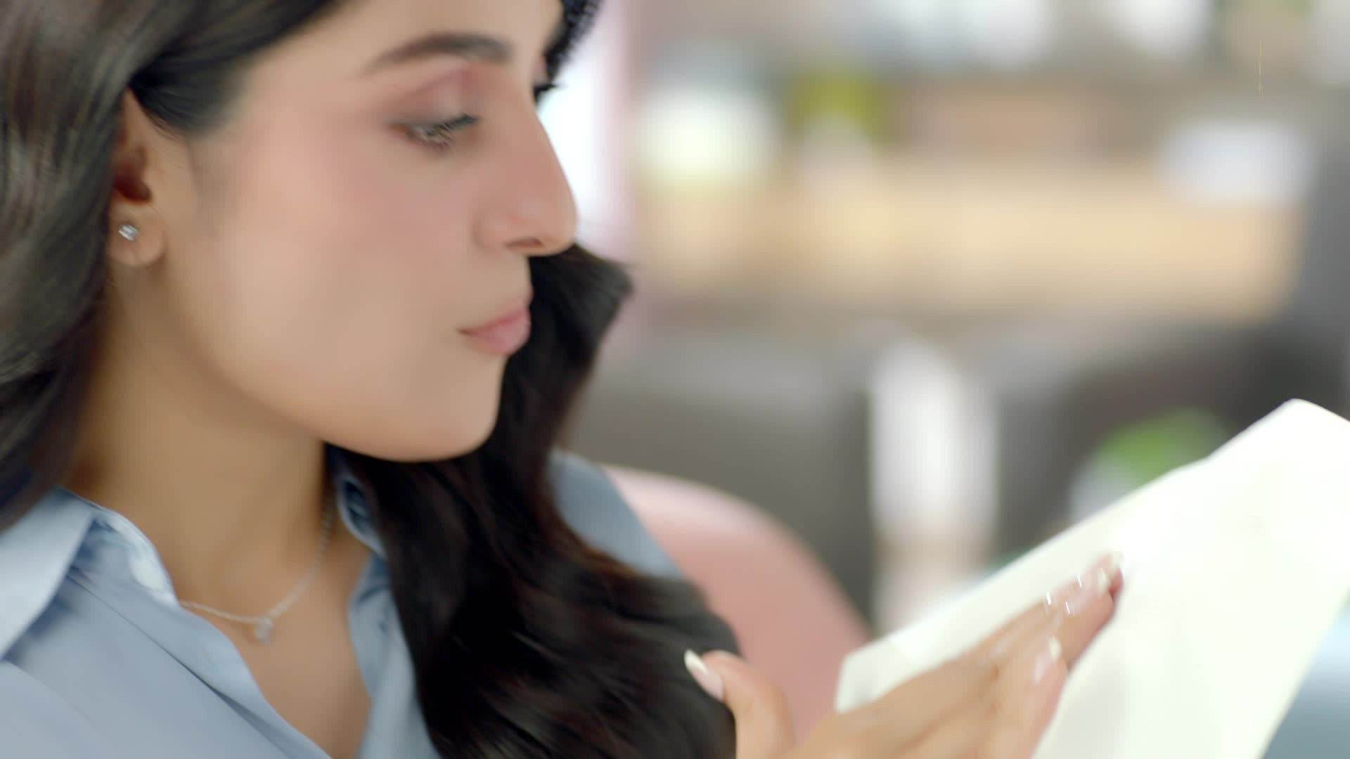 White facial tissue held in hand next to a person’s face