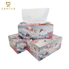Multi-pack tissue boxes with floral print and white tissues peeking out