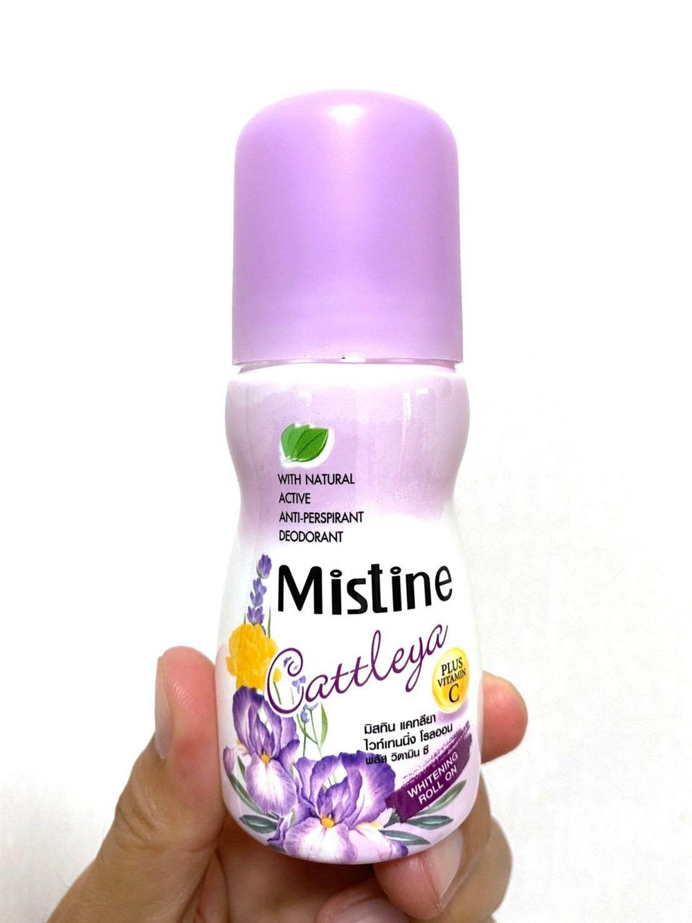 Hand holding Mistine Cattleya roll-on deodorant bottle with purple cap