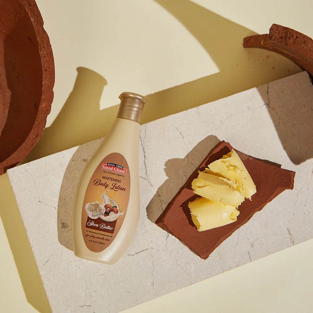 Shea butter body lotion bottle beside shea butter and cream textures