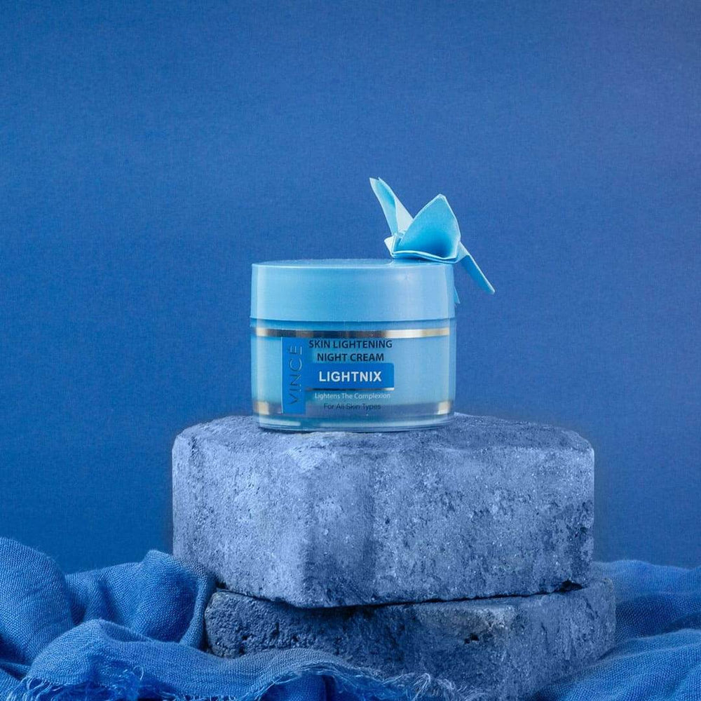 Vince skin lightening night cream jar on gray stone pedestal with blue lid